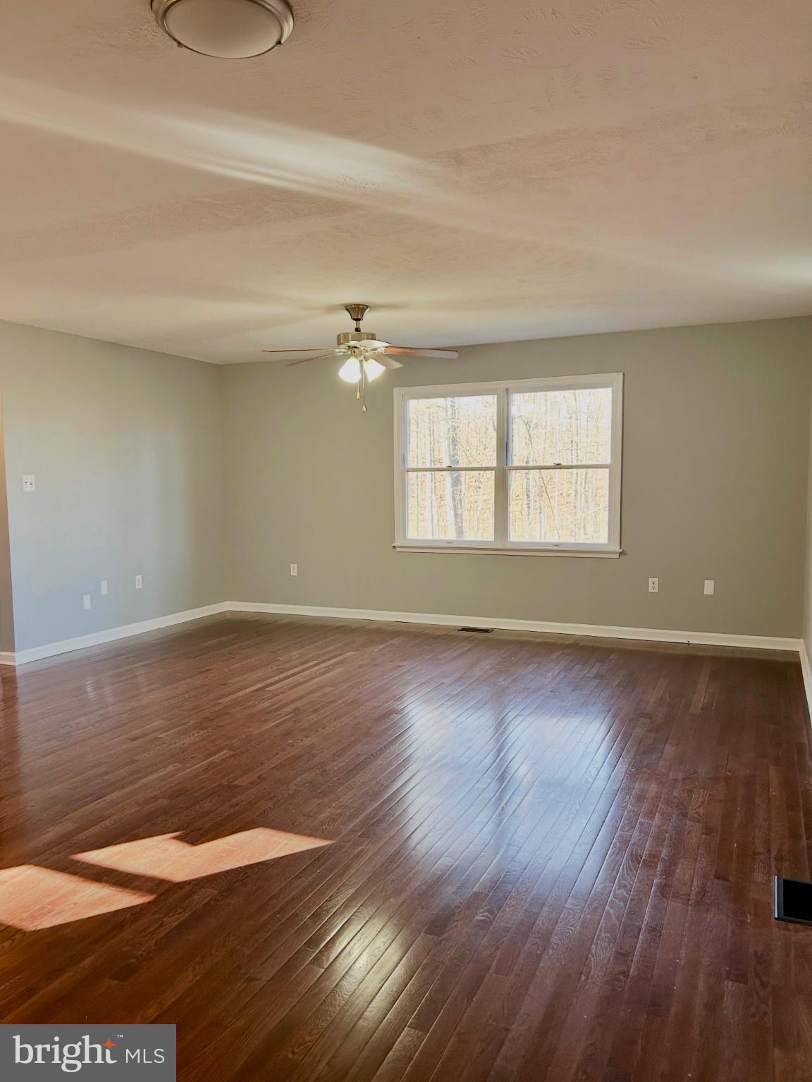 138 Parkside Road Linden, VA 22642 - Photo 7 of 38 an empty room with wooden floor and windows