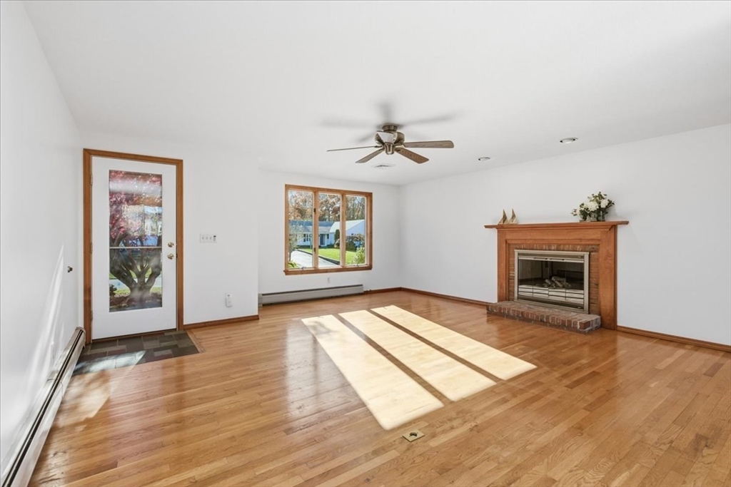 205 James Otis Road Barnstable, MA 02632 - Photo 11 of 41 wooden floor in an empty room with a fireplace