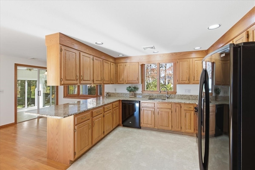 205 James Otis Road Barnstable, MA 02632 - Photo 12 of 41 a kitchen with stainless steel appliances granite countertop a refrigerator and a sink