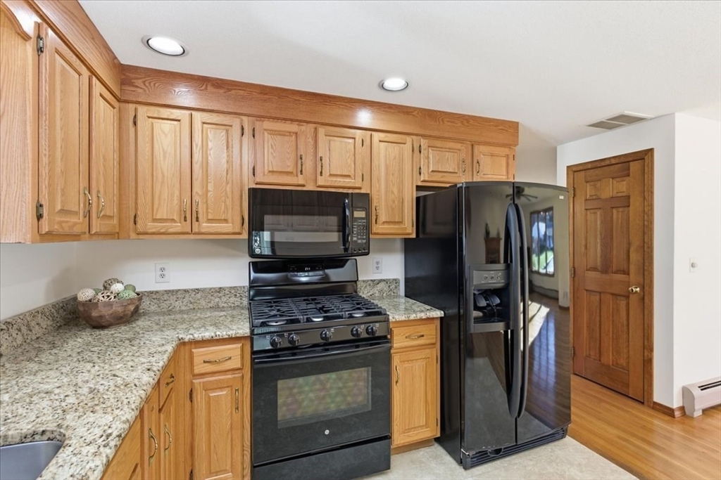 205 James Otis Road Barnstable, MA 02632 - Photo 13 of 41 a kitchen with stainless steel appliances granite countertop a refrigerator stove and sink
