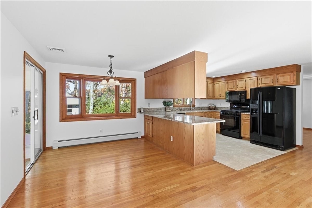 205 James Otis Road Barnstable, MA 02632 - Photo 14 of 41 a open kitchen with stainless steel appliances granite countertop a stove top oven a sink and a refrigerator