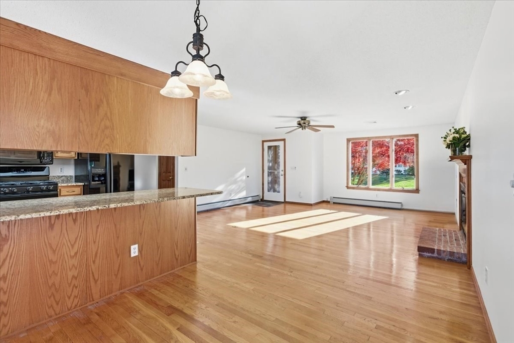 205 James Otis Road Barnstable, MA 02632 - Photo 15 of 41 a view of a kitchen with kitchen island a sink wooden floor and a counter top space