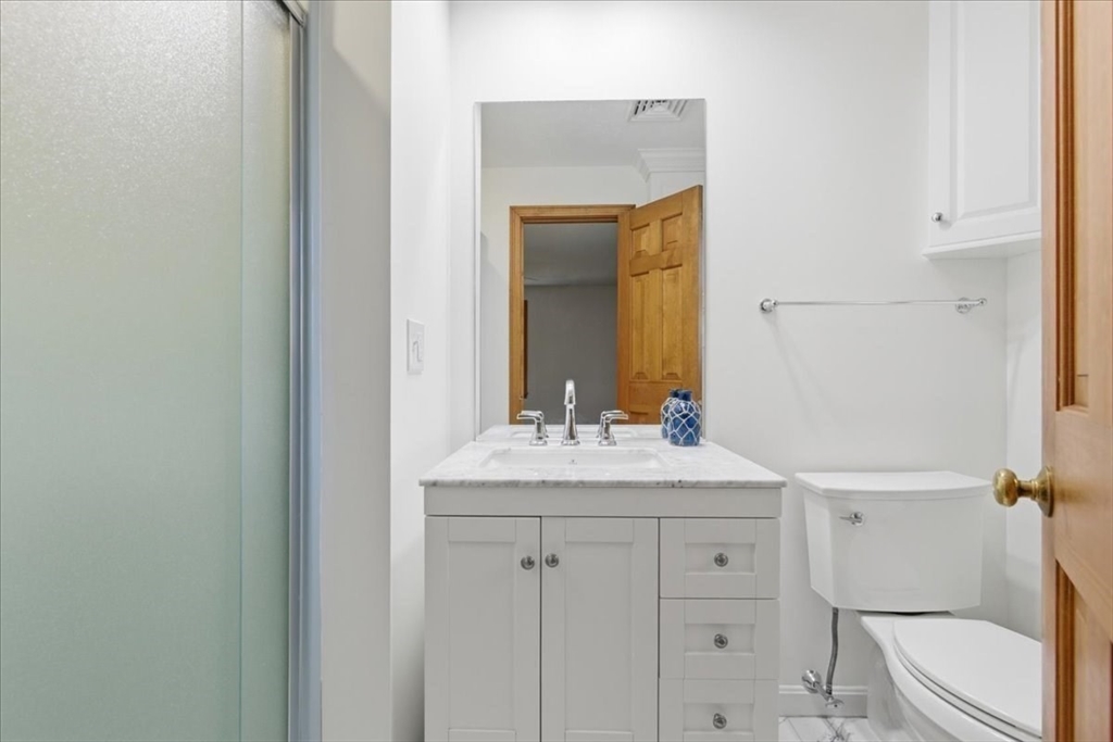 205 James Otis Road Barnstable, MA 02632 - Photo 25 of 41 a bathroom with a granite countertop sink toilet and mirror