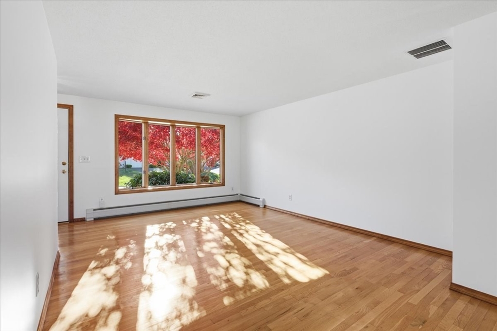 205 James Otis Road Barnstable, MA 02632 - Photo 7 of 41 a view of an empty room with wooden floor and a window