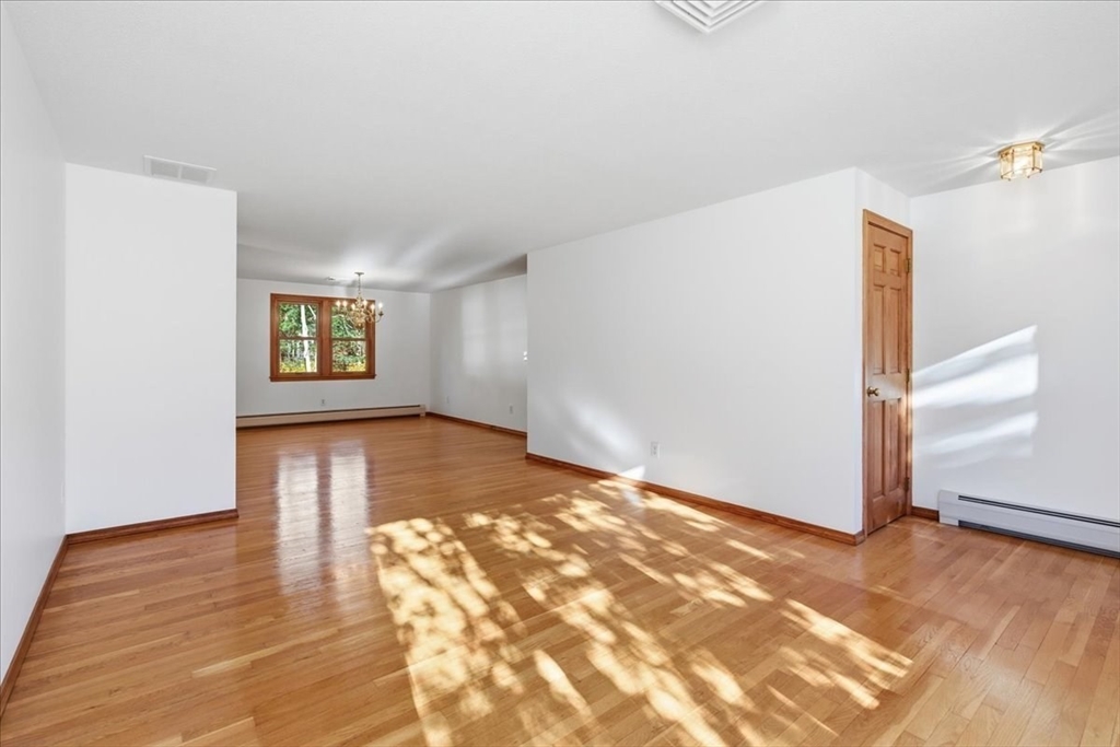 205 James Otis Road Barnstable, MA 02632 - Photo 8 of 41 a view of an empty room with wooden floor and a window