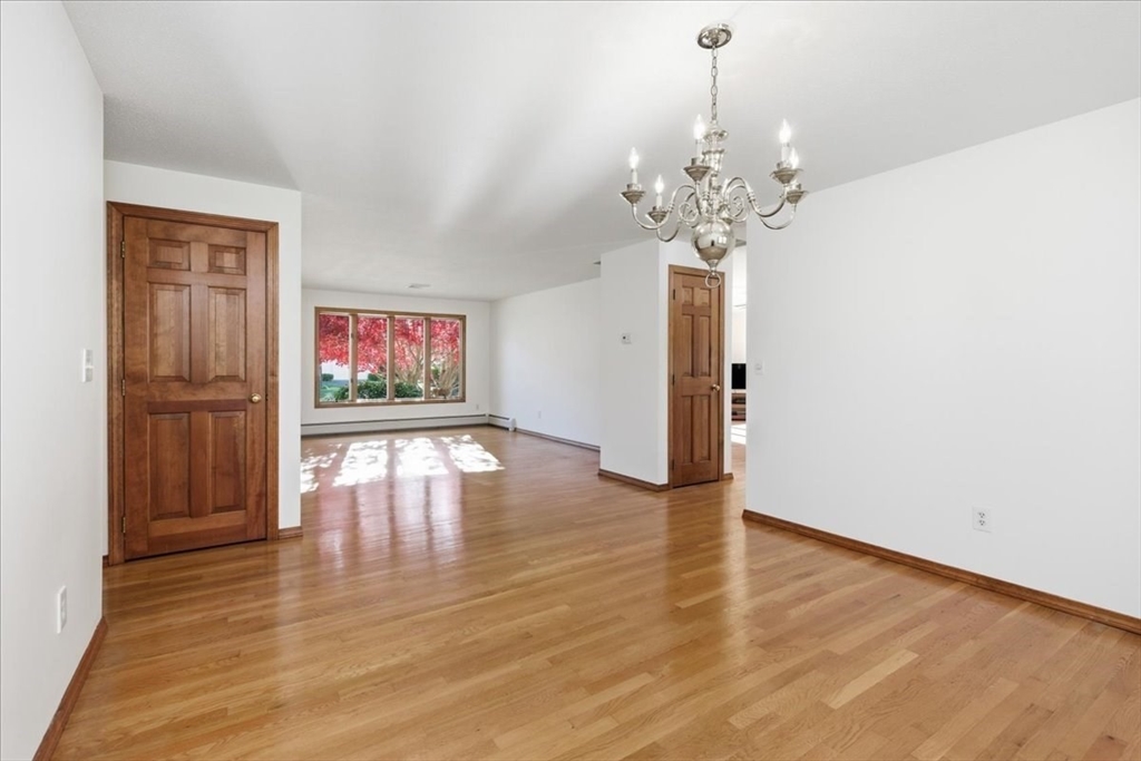 205 James Otis Road Barnstable, MA 02632 - Photo 9 of 41 a view of an empty room with window and wooden floor