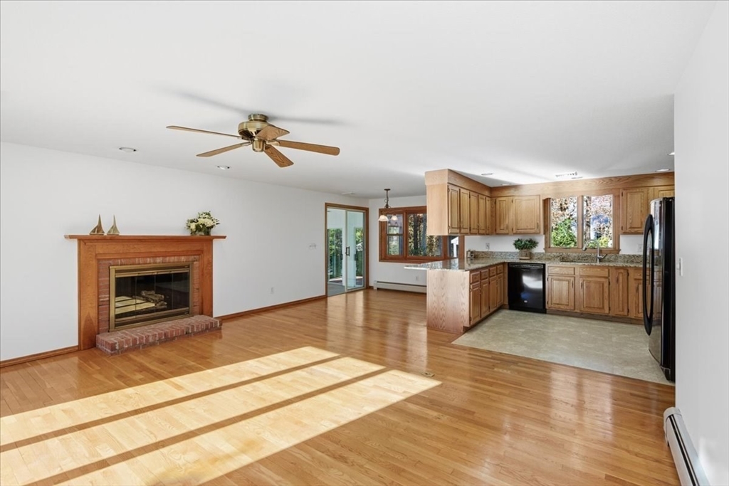 205 James Otis Road Barnstable, MA 02632 - Photo 10 of 41 a living room with stainless steel appliances furniture a fireplace and a kitchen view
