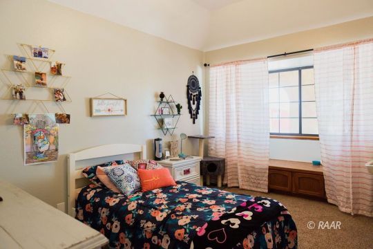 308 North Nolan Street Ridgecrest, CA 93555 - Photo 22 of 35 a bedroom with a bed and a window