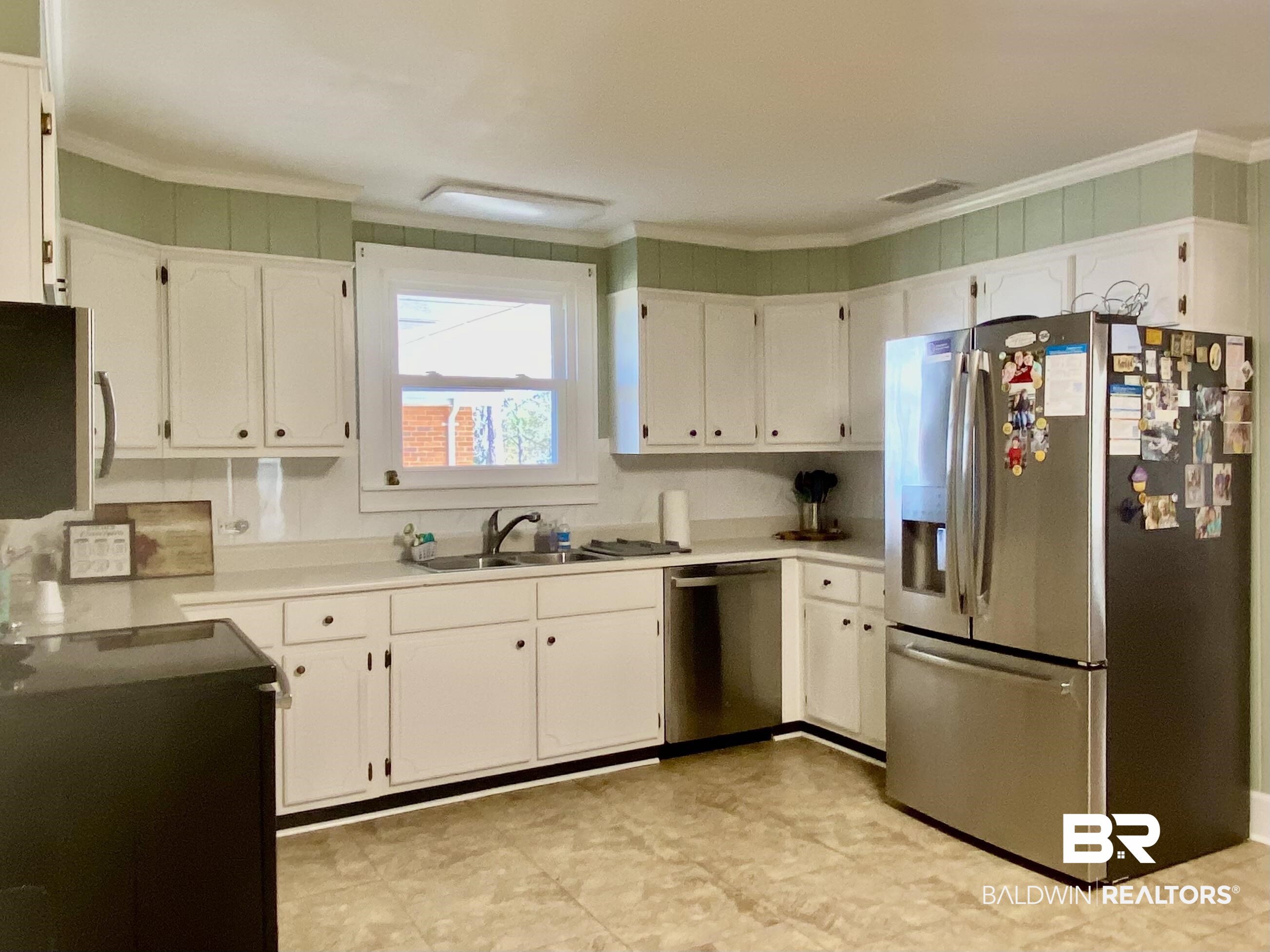 2711 County Road 5 Repton, AL 36475 - Photo 9 of 36 Kitchen with stainless steel appliances, ornamental molding, white cabinets, and sink