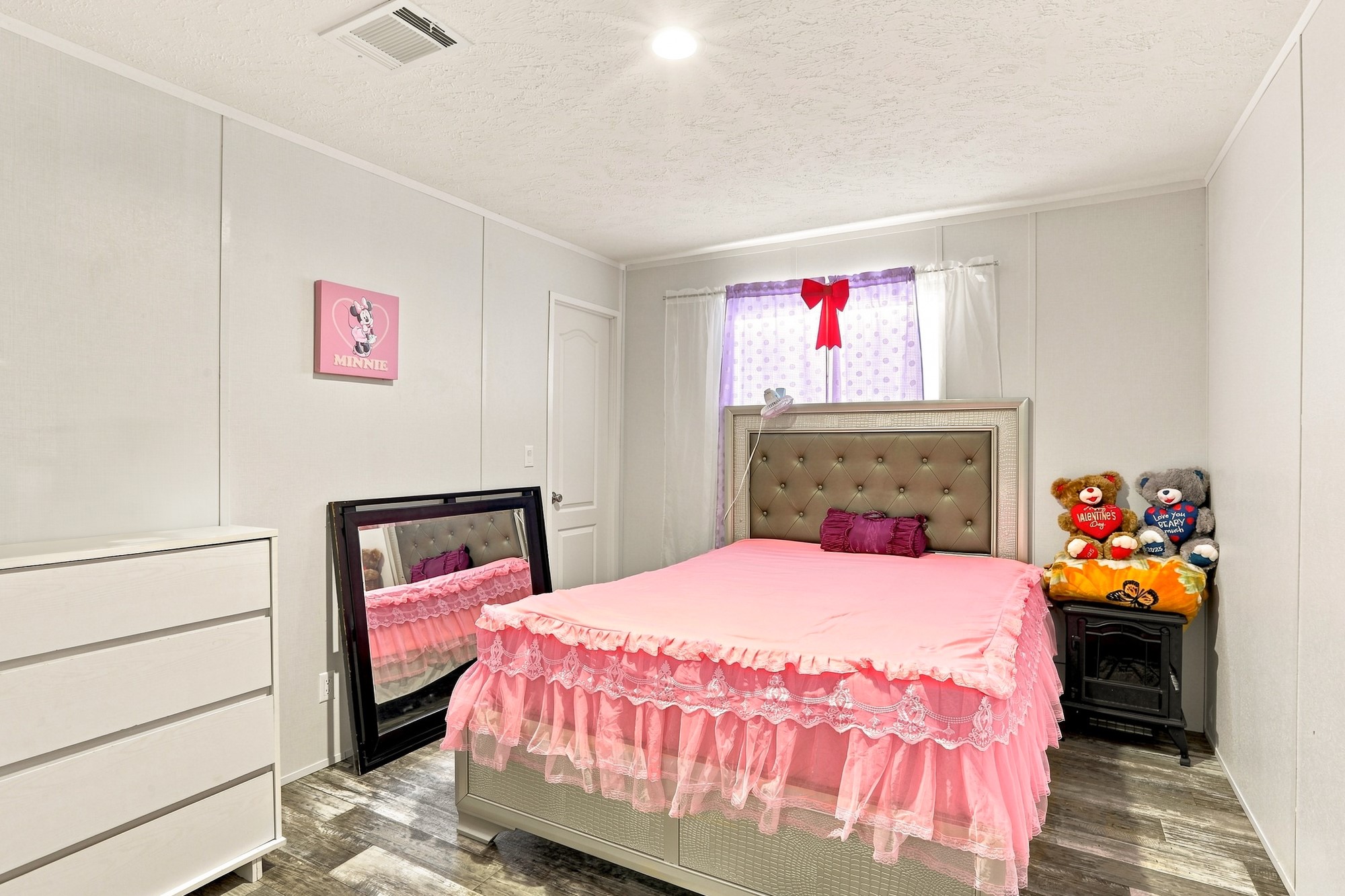 1039 Trailside Elgin, TX 78621 - Photo 14 of 24 Recessed lighting illuminates wood-look flooring and clean white walls in this cozy bedroom.