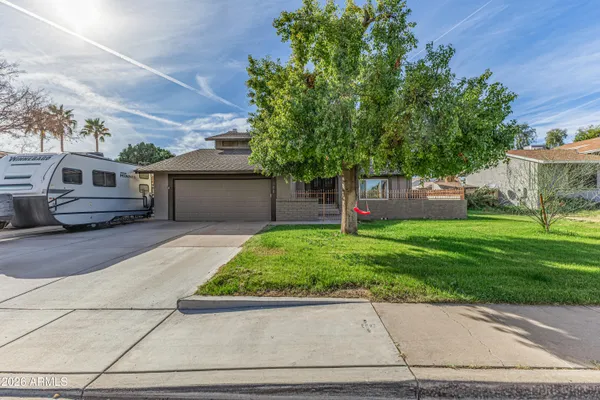a front view of a house with a yard and a garage