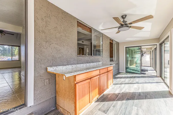 a hallway view with wooden floor and electronic appliances