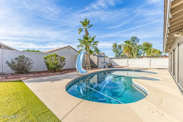 a view of a swimming pool with a lounge chair