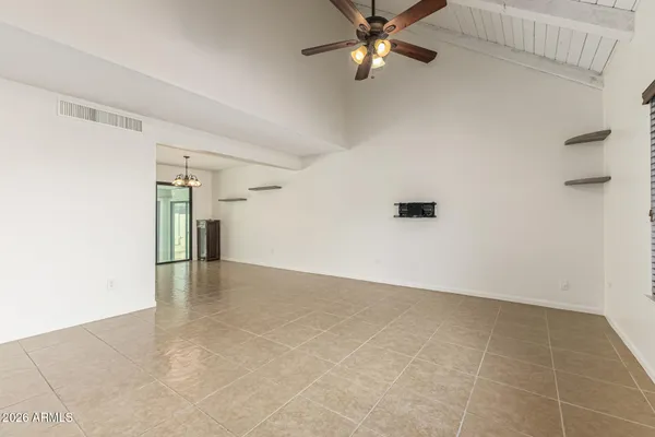 an empty room with a empty space and a ceiling fan