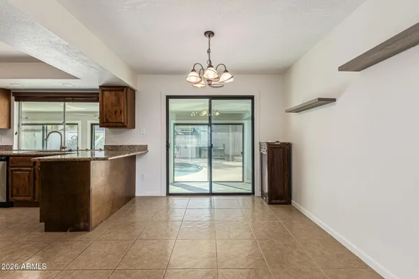 a large kitchen with granite countertop a stove and a sink