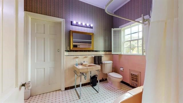 5975 Calder Avenue Beaumont, TX 77706 - Photo 19 of 35 a bathroom with a sink toilet a mirror and shower
