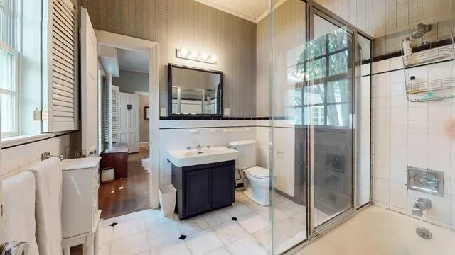 a bathroom with a shower and a sink