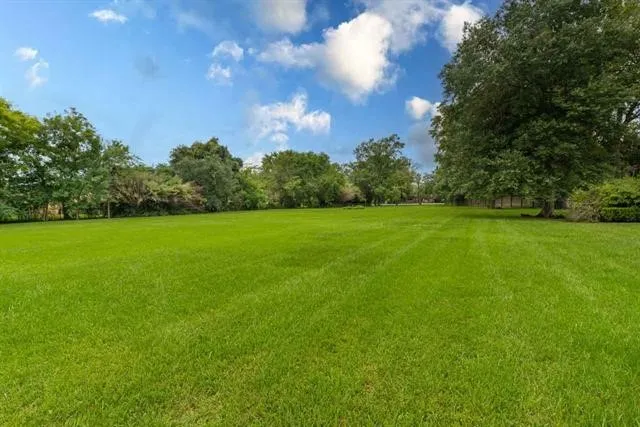 a view of a swimming pool with a yard