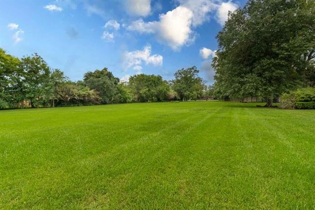 5975 Calder Avenue Beaumont, TX 77706 - Photo 26 of 35 a view of a grassy field with trees in the background