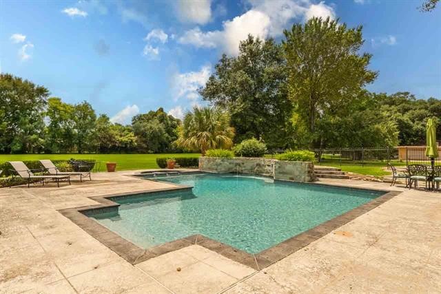 5975 Calder Avenue Beaumont, TX 77706 - Photo 27 of 35 a view of a swimming pool with a yard