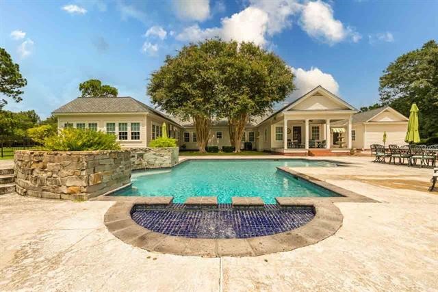 5975 Calder Avenue Beaumont, TX 77706 - Photo 28 of 35 a view of a house with a swimming pool and a yard