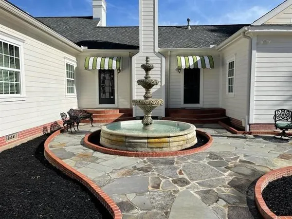 a view of a white house with a patio