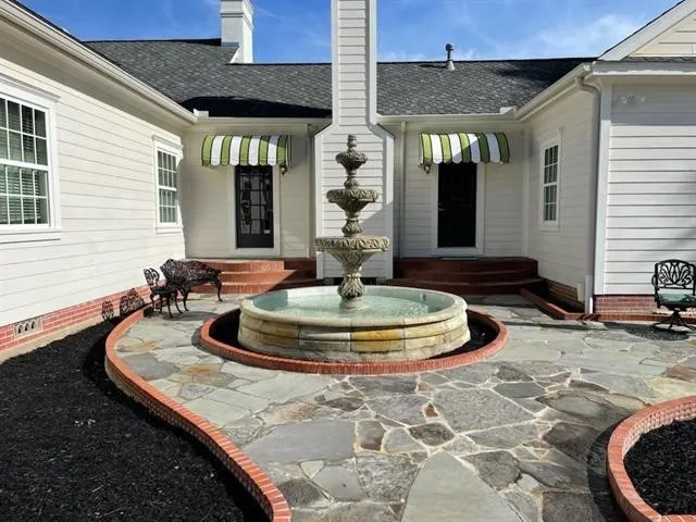 a view of a white house with a patio