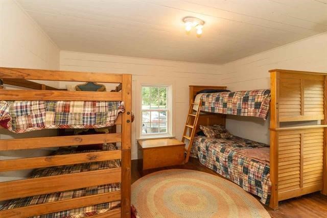 5975 Calder Avenue Beaumont, TX 77706 - Photo 35 of 35 a bedroom with a bed and wooden floor