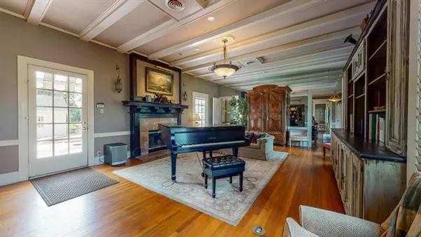 a living room with furniture a fireplace and a table
