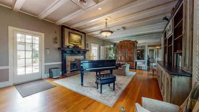 a living room with furniture a fireplace and a table