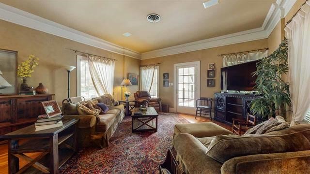 5975 Calder Avenue Beaumont, TX 77706 - Photo 9 of 35 a living room with furniture and a flat screen tv