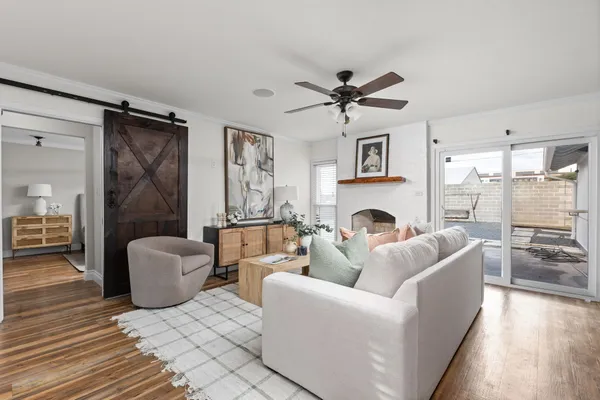 a living room with furniture fireplace and a window