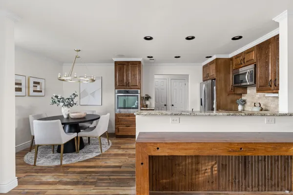 a living room with stainless steel appliances kitchen island granite countertop furniture and a kitchen view