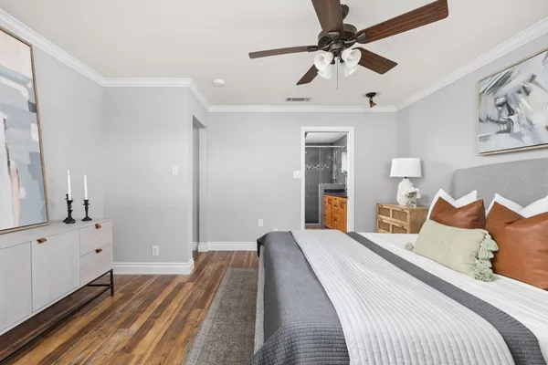 a bedroom with a bed and a chandelier