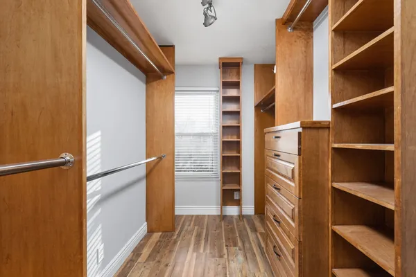 a view of walk in closet with empty racks