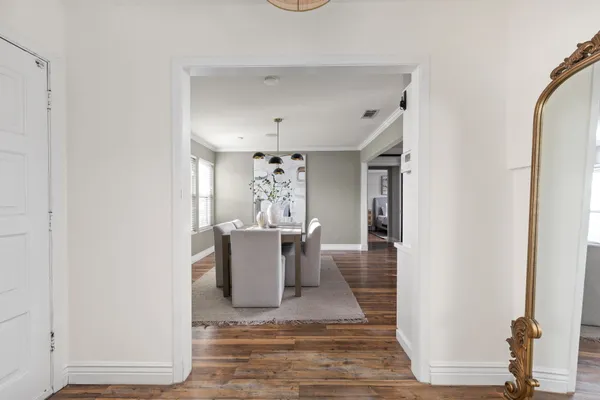 a view of a dining room with furniture and wooden floor