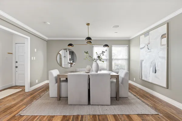 a living room with a couch and dresser with wooden floor