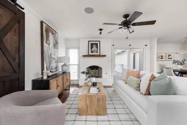 a living room with furniture a fireplace and a flat screen tv