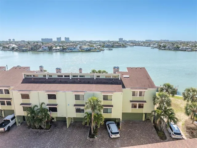 an aerial view of a house with outdoor space and lake view