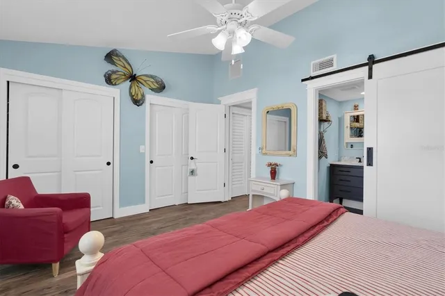 a bedroom with a bed and ceiling fan