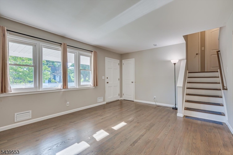 15 Woodmere Street Raritan, NJ 08869 - Photo 6 of 16 wooden floor in an empty room with a window
