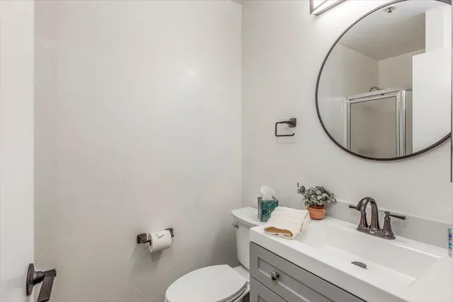 a bathroom with a sink mirror and toilet