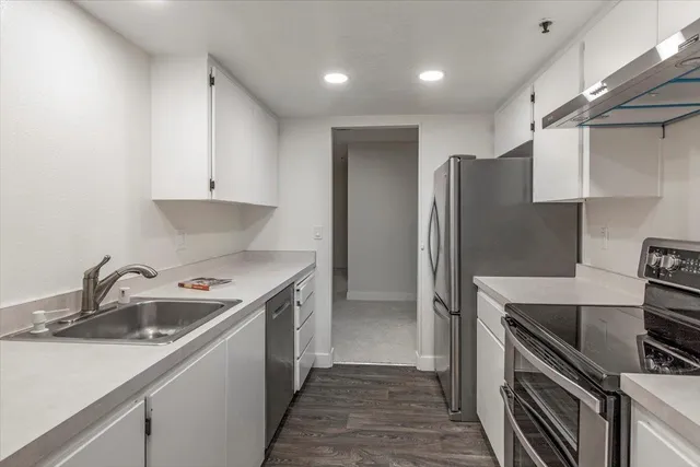 a kitchen that has a sink and a stove