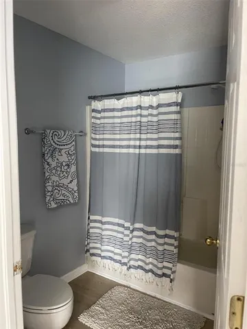 a bathroom with a toilet and a shower