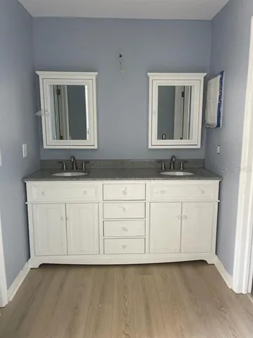 a bathroom with a sink vanity and mirror