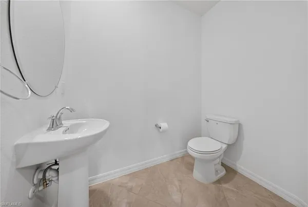 a bathroom with a sink toilet and a mirror