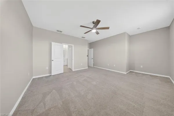 a view of an empty room with a ceiling fan