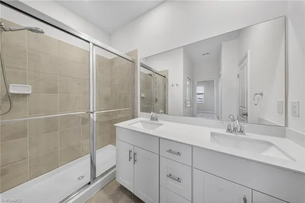a bathroom with a shower sink and mirror