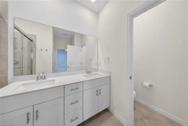 a bathroom with a double vanity sink and mirror