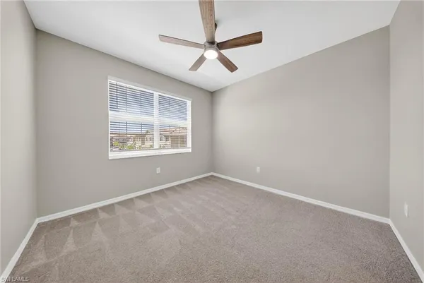 an empty room with ceiling fan and a ceiling fan